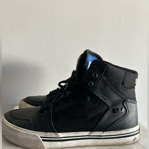 Size 4 kids, Black &White Supra shoes. Orange Stain on the white area.